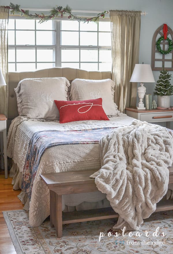 bedroom with ruched faux fur throw blanket, red pillow, french quilt, linen shams