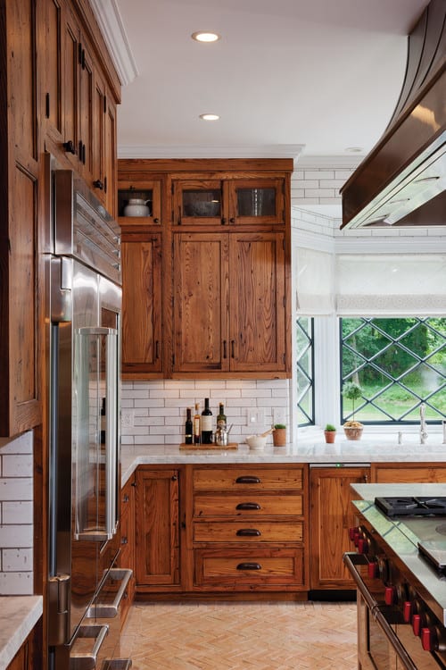 vintage farmhouse style kitchen with chestnut cabinets