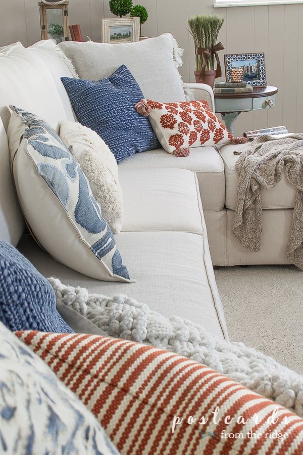 blue and orange pillows on lovesac sactional couch