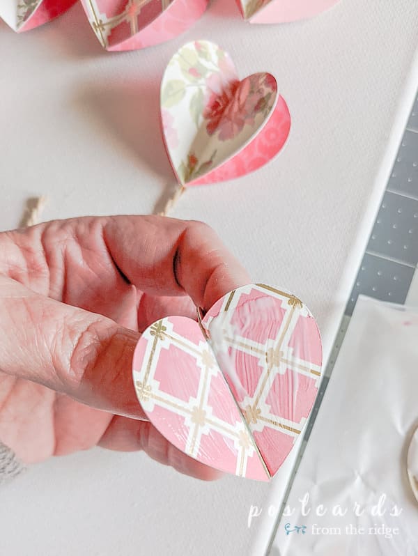 glue on the back of a 3-D paper heart