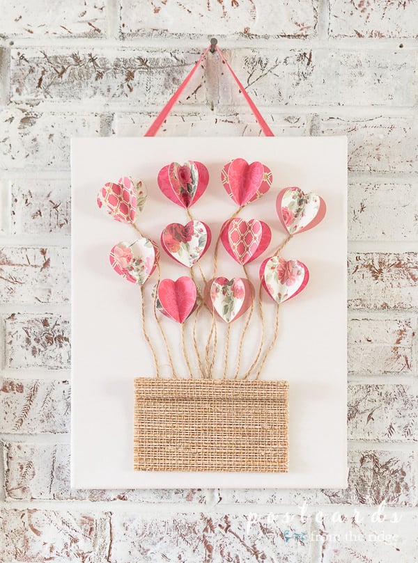 white canvas with 3-D paper hearts and twin with woven wood piece