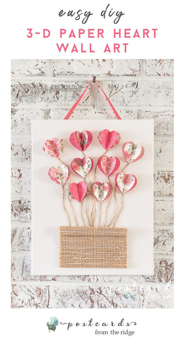 3-D paper hearts with twine on white canvas