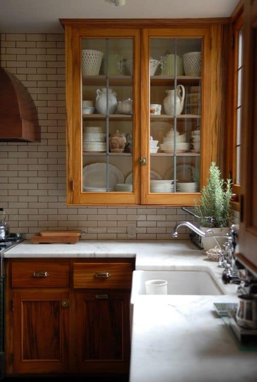vintage style kitchen with wood cabinets and subway tile