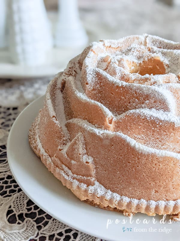 pound cake made into a rose shape and sprinkled with powdered sugar