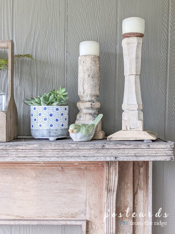 rustic mantel with blue and white planter and green stoneware bird