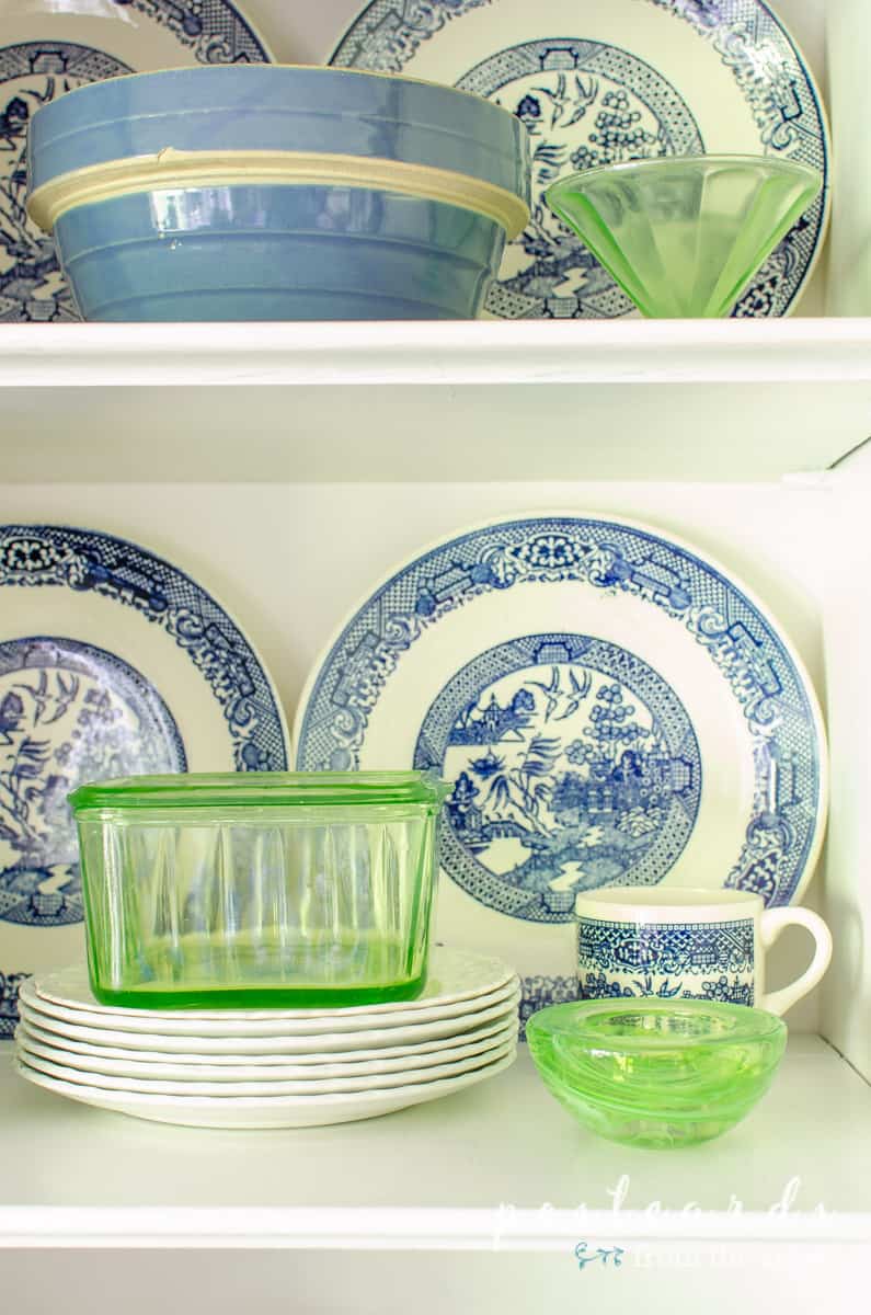 blue and white dishes in a vintage hutch