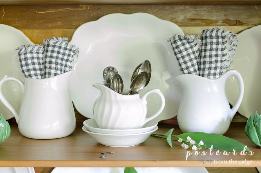little white ironstone pitchers with black and white napkins