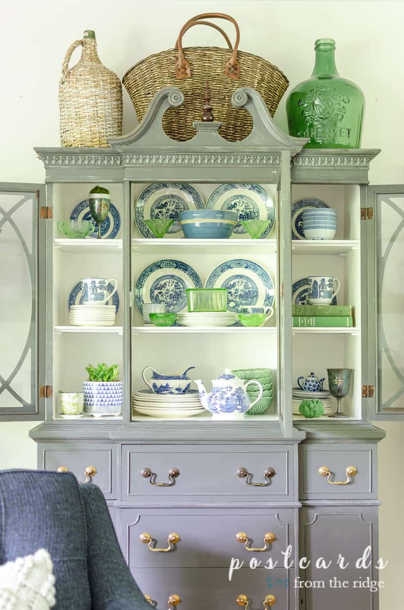 painted china hutch with blue and green dishes