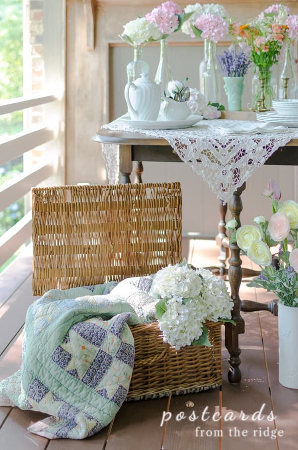 vintage wicker basket with quilt and hydrangeas