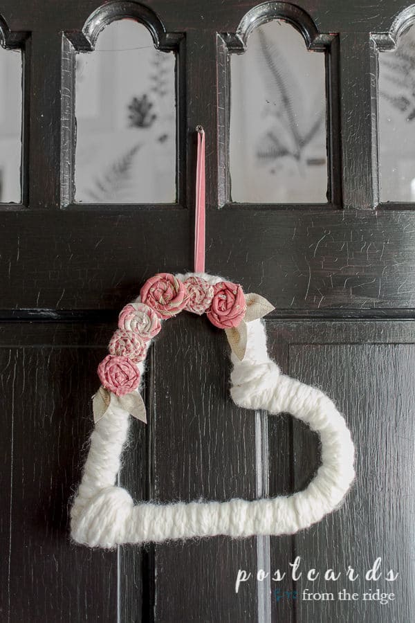 heart shaped yarn wreath with fabric flowers