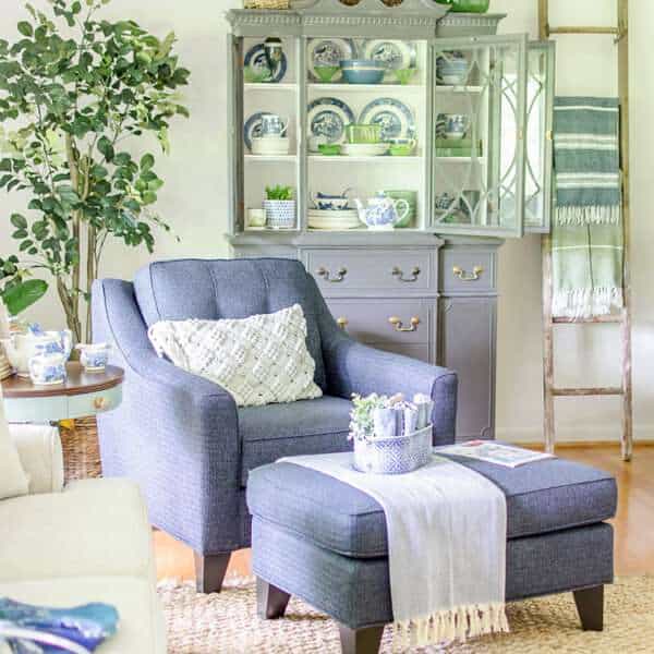 blue chair and China cabinet in living room