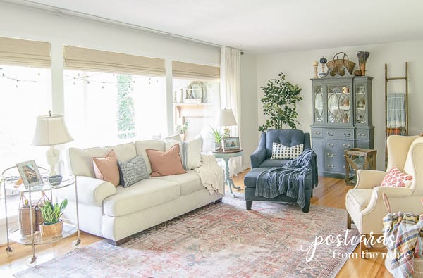 living room with white sofa and blue chair and ottoman