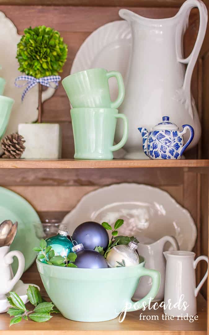 vintage jadeite mugs and batter bowl with blue christmas ornaments and white ironstone
