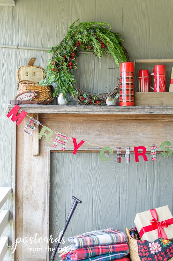 hand-made Christmas wreath on decorations on a rustic outdoor mantel