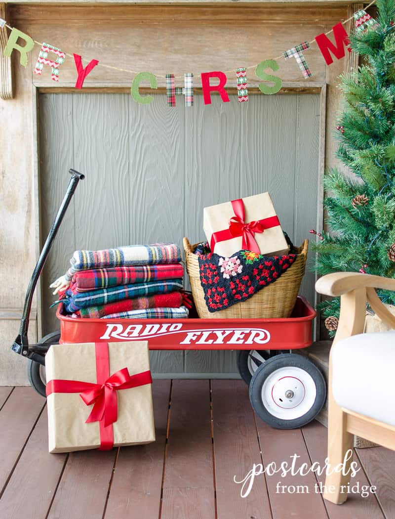 Christmas porch decor with red wagon and vintage plaid blankets