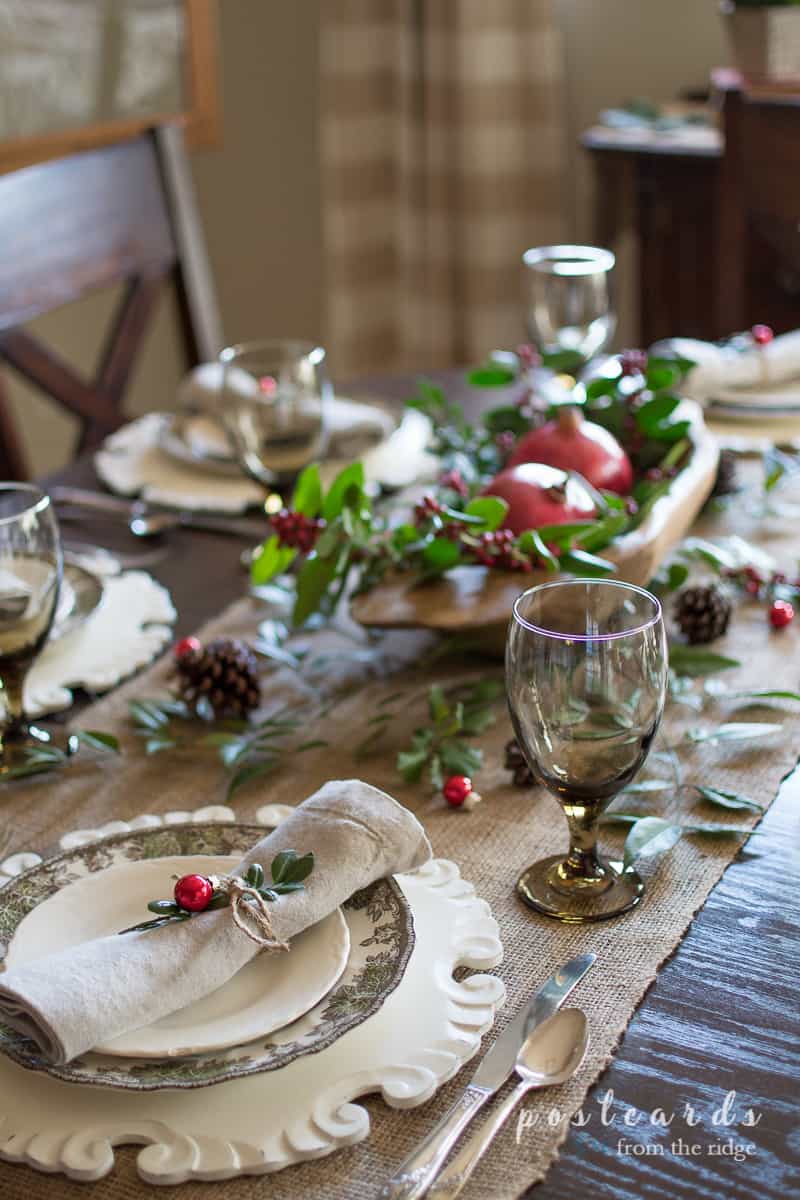 Christmas table with burlap runner and white dishes with linen napkins