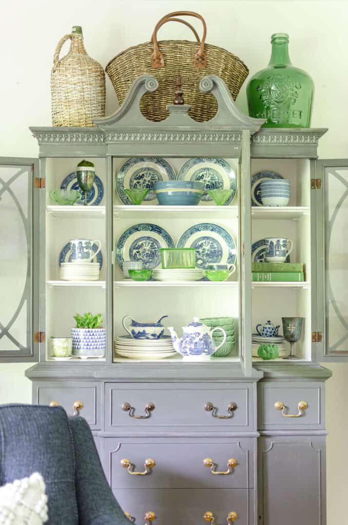antique painted hutch with blue and green dishes
