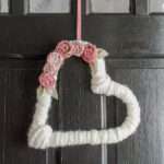 heart shaped yarn wrapped wreath with fabric flowers