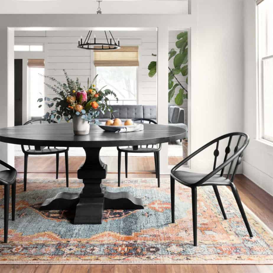 graham houston area rug from magnolia home in dining room with black wood pedestal table and black chairs