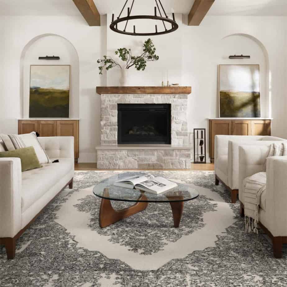 annie manor area rug from magnolia home in living room with stone fireplace and white walls