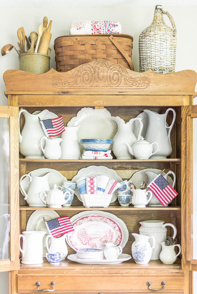 vintage hutch with white ironstone pieces