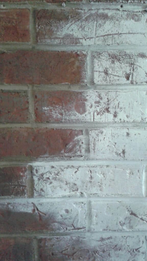 white paint on red brick fireplace