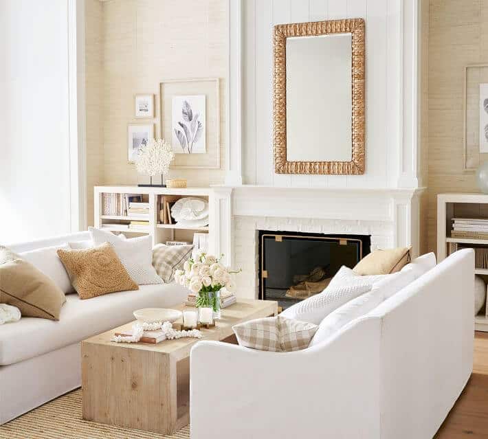 coastal grandmother style living room with grasscloth walls and white sofas