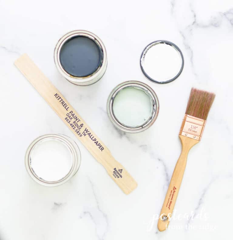 paint cans with brush and mixing stick
