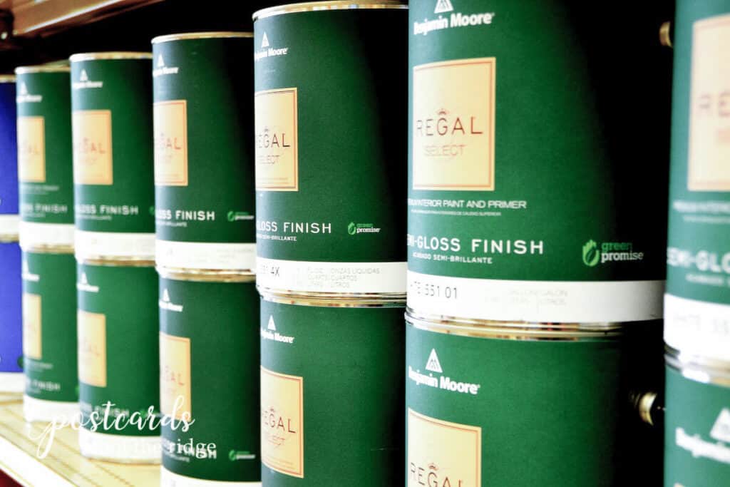 green paint cans stacked on a shelf
