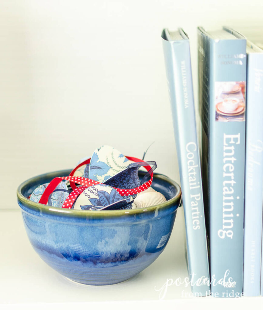 blue pottery bowl with red ribbon