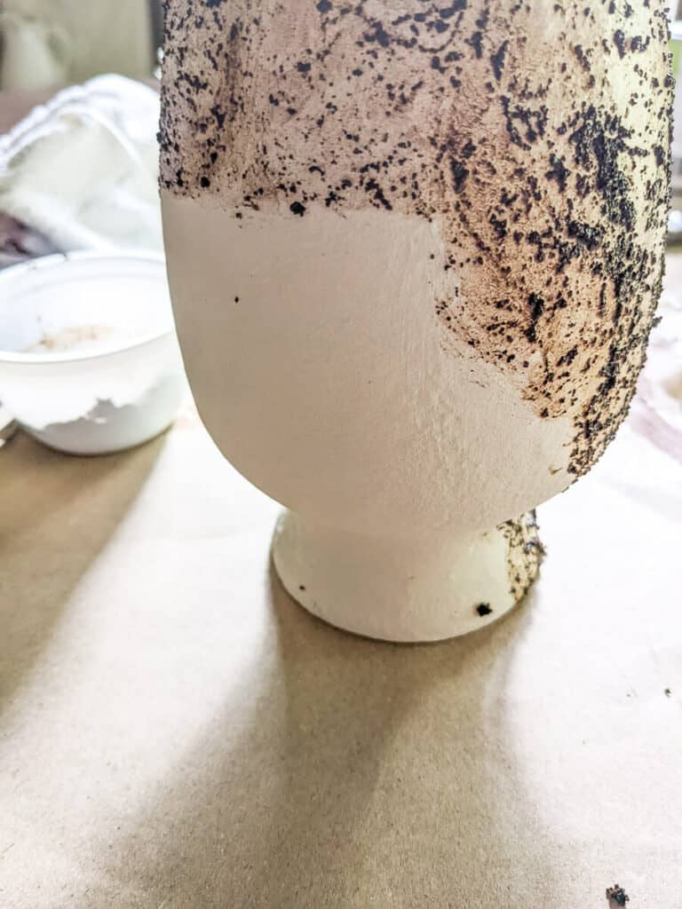 painted glass vase with coffee grounds smeared on it for color