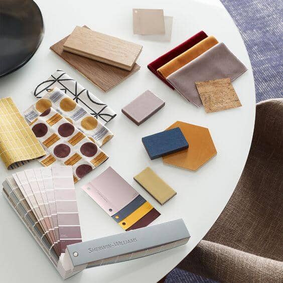 paint chips and fabric samples on a white table