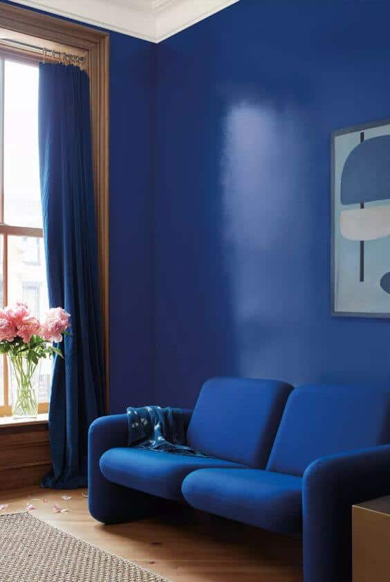 living room with dark blue walls and sofa