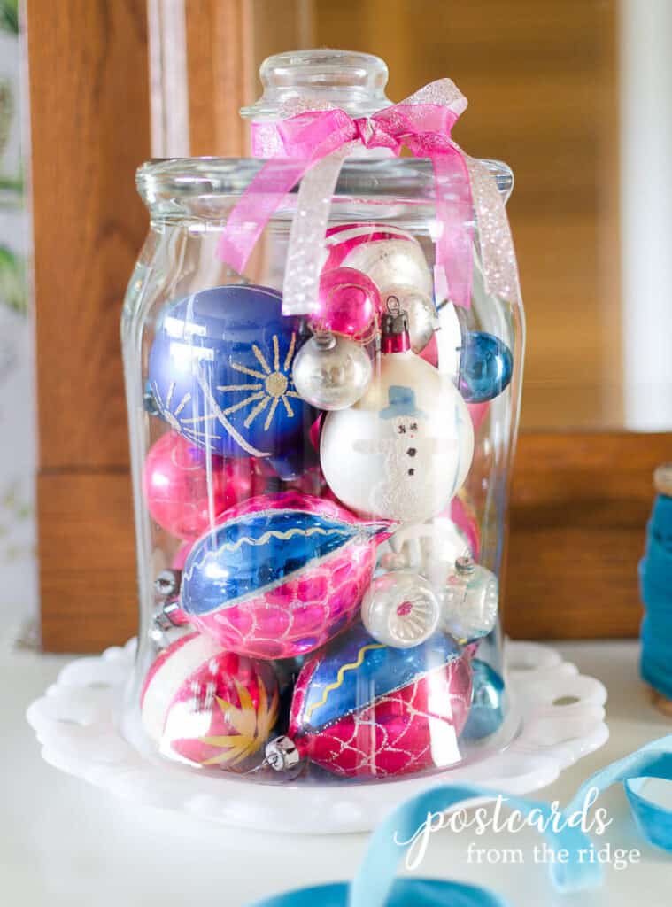 vintage pink and blue mercury glass ornaments under a glass cloche