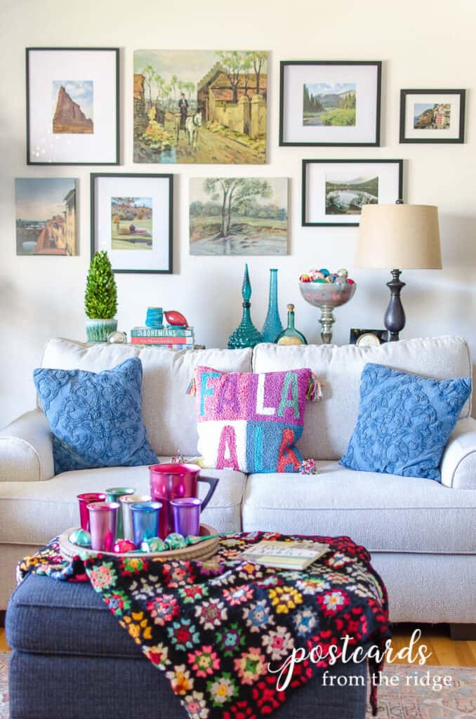 living room with gallery wall and bright accent colors with thrifted decor