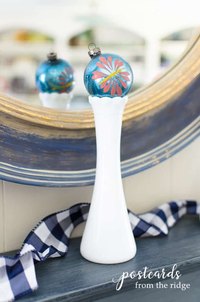 vintage mercury glass Christmas ornament in white milk glass vase