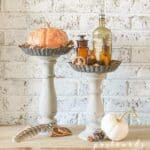 faux pumpkins on pedestal
