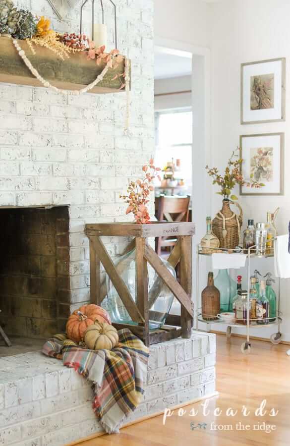 realistic faux pumpkins on fireplace hearth