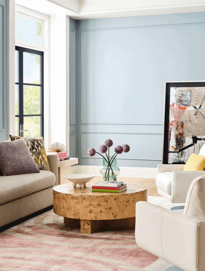 Sherwin Williams Dutch Tile Blue walls in a modern living room with a wood coffee table and soft colored upholstered furniture.