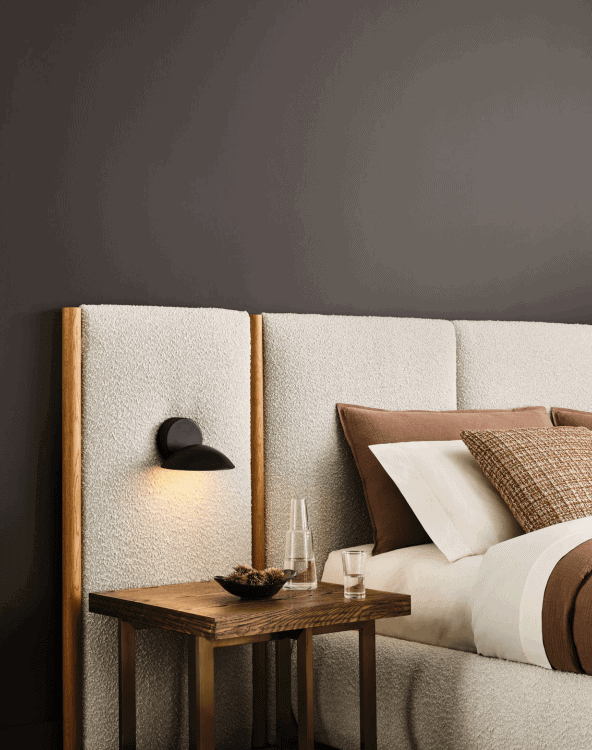 Sherwin Williams Clove SW 9605 painted bedroom with upholstered headboard and wood night stand