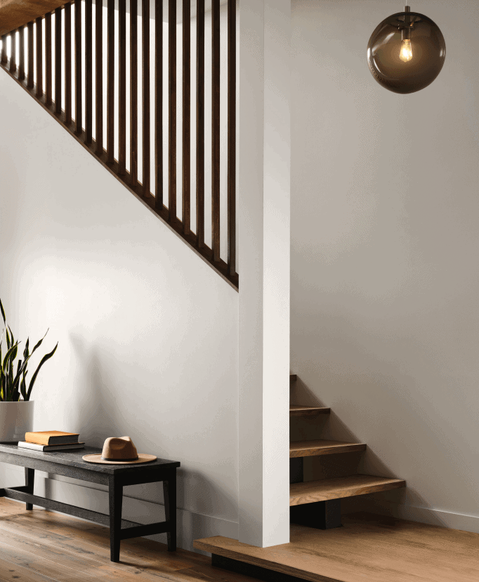 Sherwin Williams Drift of Mist SW 9166 painted entry with wood floors and stairs