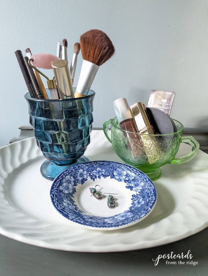 cups and saucers used to organize makeup and jewelry