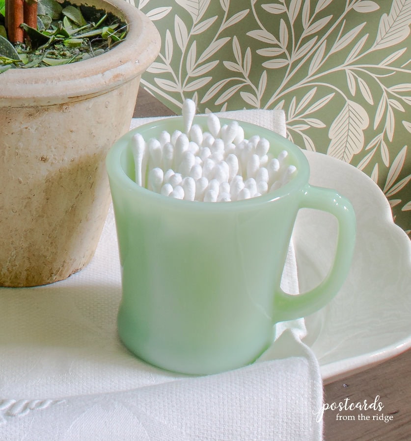 vintage jadeite mug with cotton swabs q tips